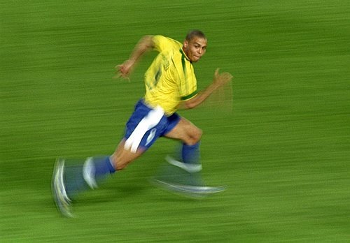 Ronaldo sprinting in Brazil kit, motion-blurred, defenders out of frame